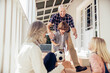© Marko Geber - Grandparents and grandchildren having fun with a soccer ball on house porch