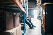 © Davor - Tired young man taking break from working in warehouse