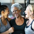 Group of mature women laughing while telling stories in gym