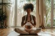Young black woman doing yoga at home