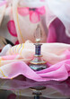 Perfume and rose, feminine vibe, pink glass container 