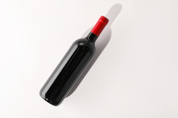 Sticker - Bottle of expensive red wine on white background, top view. Space for text