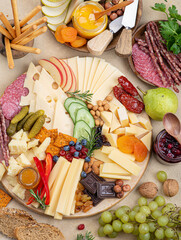 Wall Mural - Cheese plate with different types of cheese, fruits, nuts on a light background