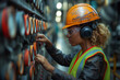 portrait of woman in safety wear working inside factory/power plant
