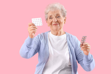 Sticker - Senior woman with pills on pink background