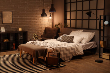 Wall Mural - Interior of bedroom with blanket on bed and glowing lamps in evening