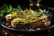 Toast with avocado, seeds and arugula on black plate. Avocado Toast. Healthy food concept with copy space. Vegan Food Concept with copy space.