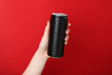 Wall Mural - Woman with energy drink on red background, closeup