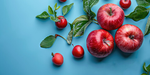 Wall Mural - cherries and red apples on blue background 