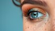 Close-up shot of beautiful woman's blue eye with makeup.