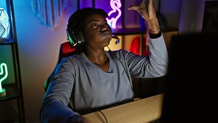 Canvas Print - Furious young black woman with dreadlocks losing her cool while gaming. mad shouts and wild arms express her frustration in the gaming room.