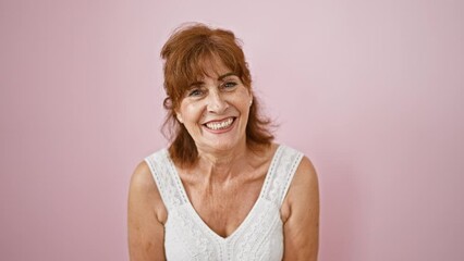 Poster - Crazy-fun middle age woman makes comical fish face gesture in pink dress over isolated background