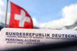 Flagge der Schweiz und deutscher Personalausweis