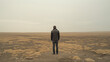 A man looking at a barren land
