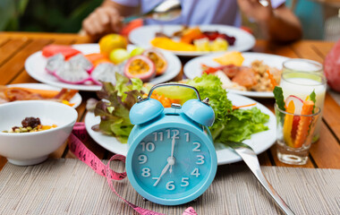 Wall Mural - Blue alarm clock with IF (Intermittent Fasting) 16 and 8 diet rule and weight loss concept.-Diet plan concept