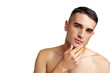 © fotofabrika - Young attractive brunet guy with perfect skin touching chin on white background
