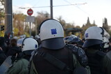 Fototapeta Paryż - Armed policemen in white protective helmets while control public protest
