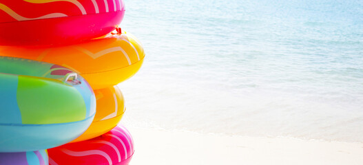 Wall Mural - Inflatable rings on the beach. Summer concept