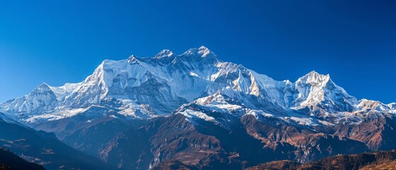 Wall Mural - panoramic view of pristine snow-covered mountain peaks under blue sky