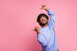 Photo portrait of nice young guy point look excited crazy empty space dressed stylish blue outfit isolated on pink color background