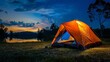 The outdoor camping tent is set on a grassy area. Illuminated by a warm glow at night under the blue sky at twilight.