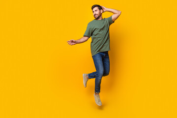 Canvas Print - Full body photo of attractive young man jump look elegant empty space dressed stylish khaki clothes isolated on yellow color background