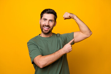 Sticker - Photo portrait of nice young male point show muscles biceps dressed stylish khaki garment isolated on yellow color background