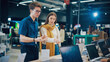 © Gorodenkoff - Young Woman Having a Conversation with a Salesperson in Home Electronics Store while Selecting a Laptop. Stylish Customer Wishes to Buy a Computer Device. Shopper Explores Latest Options with Expert