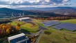 aerial shot of a renewable energy research complex, showcasing experimental wind turbines and solar fields