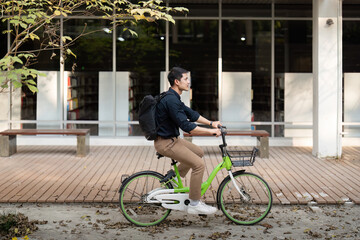 Businessman and bicycle in city to work with eco friendly transport. happy businessman professional riding a bicycle in urban street