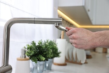 Poster - Plumber repairing faucet with spanner indoors, closeup