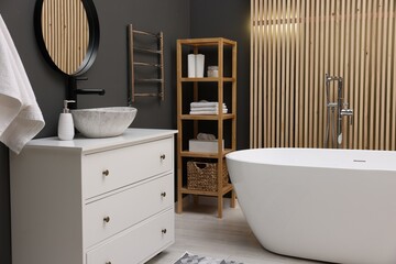 Poster - Stylish bathroom interior with heated towel rail and modern furniture