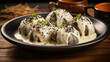 Steamed sweet gnocchi with chocolate filling and vanilla sauce sprinkled with poppy seeds