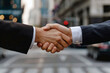 Close-up image of two businessmen shaking hands with each other.