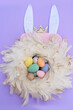 Easter scene with colored eggs in nest with rabbit ears