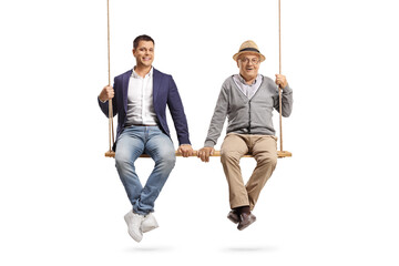 Wall Mural - Son and elderly father sitting together on a big wooden swing