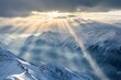 Snow capped mountain peaks with sunlight piercing through clouds