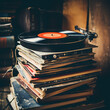 A stack of old vinyl records with retro headphones