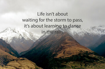 Wall Mural - Snow capped mountain with inspirational quotes life isn’t about waiting for the storm to pass, it’s about learning to dance in the rain