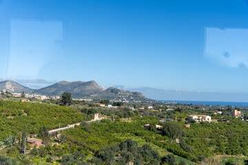 Wall Mural - A beautiful view of a valley with a mountain range in the background