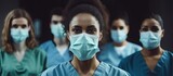Fototapeta Zachód słońca - Diverse Group of Medical Professionals in Protective Masks Working Together in Hospital Setting