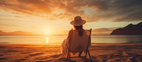 Canvas Print - Elegant Woman in Stylish Dress and Hat Posing Gracefully on Seaside Shoreline