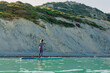 © artifirsov - Woman on stand up paddle board, quiet ocean on sunny summer day. Relaxing on sea