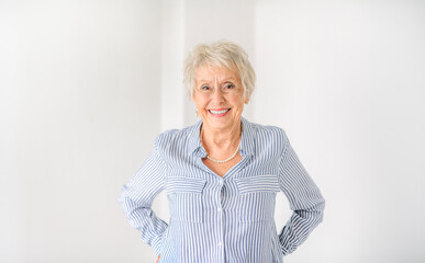 Wall Mural - senior lady posing at home portrait close to a window