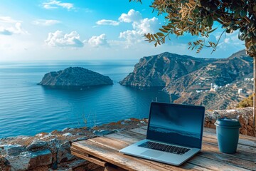 Wall Mural - A laptop is open on a wooden table overlooking the ocean