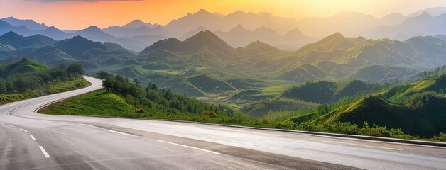 Wall Mural - Winding Road through Mountainous Landscape at Sunset