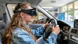 © Ilja - Virtual reality driving school exam  young woman in car simulator controls virtual machine.