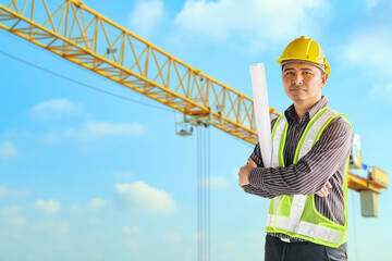 Wall Mural - construction engineer worker in protective helmet and blueprints paper on hand at building site background