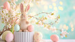 Cute toy Easter bunny on a podium with Easter eggs in soft pastel colors against the background of spring flowers, copy space on the right