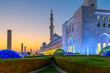 The Sheikh Zayed Grand Mosque, the largest mosque in the UAE, illuminated at sunset in Abu Dhabi, United Arab Emirates.	